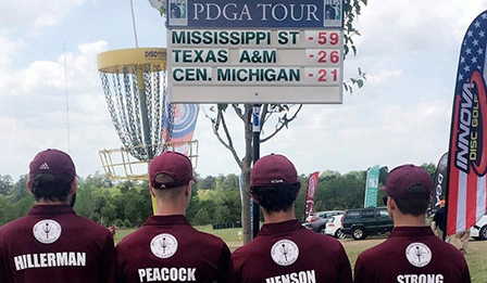 MSU Disc Golf team looks at their winning scoreboard