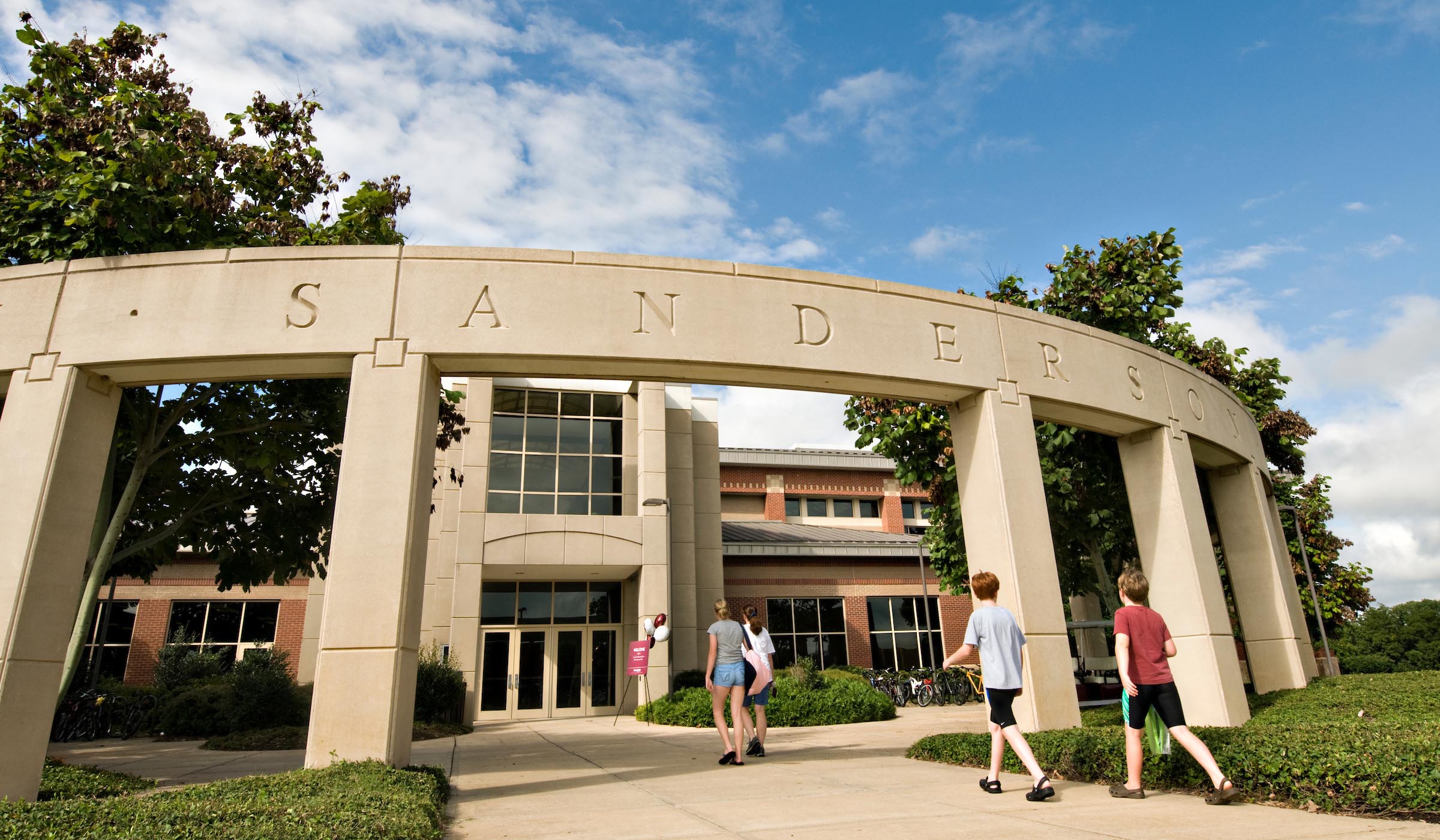 Exterior of Sanderson Center as people of various ages walk inside.