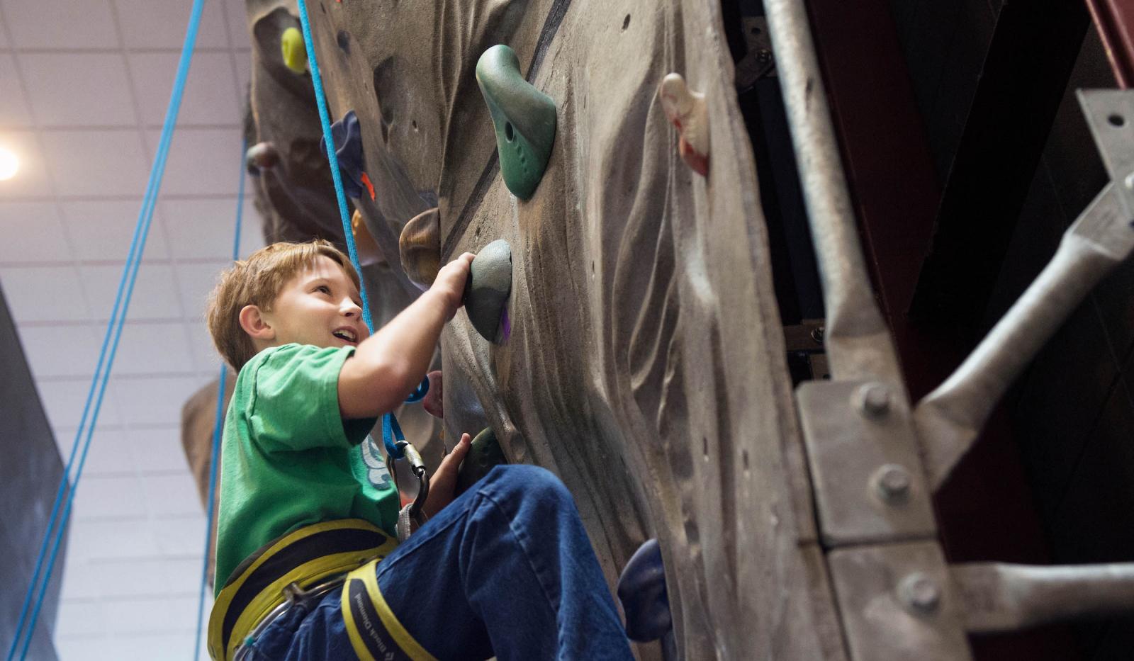 Child climbing rock wall in the Sanderson Center