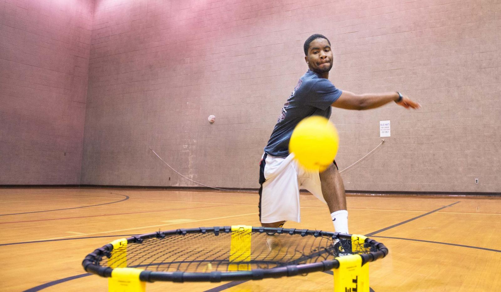 A player spikes the ball towards the camera while playing Spikeball